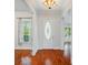 Bright entryway showcasing hardwood floors, decorative lighting, and a charming front door at 648 Revival Row, Fort Mill, SC 29708