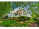 Lovely two-story home with a spacious front porch, an American flag, and a well-maintained lawn at 648 Revival Row, Fort Mill, SC 29708