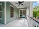 Cozy front porch with a hanging swing, ceiling fan, and views of the surrounding greenery at 648 Revival Row, Fort Mill, SC 29708