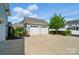 Two detached two-car garages with wide driveway and beautiful landscaping at 648 Revival Row, Fort Mill, SC 29708