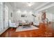 Cozy living room featuring hardwood floors, staircase access, and plenty of natural light at 648 Revival Row, Fort Mill, SC 29708