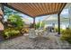 Paver patio with pergola and outdoor seating, grilling area, and landscaped backyard at 648 Revival Row, Fort Mill, SC 29708