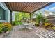 Outdoor patio seating area with pergola, brick pavers, and brick privacy wall at 648 Revival Row, Fort Mill, SC 29708