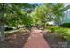 Brick walkway lined with benches, trees, and landscaping at 648 Revival Row, Fort Mill, SC 29708