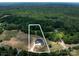 Aerial shot of a sprawling property showcasing a modern farmhouse surrounded by mature trees at 6511 Rehobeth Rd, Waxhaw, NC 28173