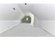 An attic or upstairs bonus room space features white walls and ceiling with a single window at 6511 Rehobeth Rd, Waxhaw, NC 28173