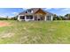 This backyard is still under construction and features a covered porch and sliding doors at 6511 Rehobeth Rd, Waxhaw, NC 28173