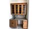 Elegant wet bar with light wood cabinets, glass shelving, and a stylish gray countertop at 6511 Rehobeth Rd, Waxhaw, NC 28173