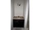 Powder room with a single sink and dark cabinet at 6511 Rehobeth Rd, Waxhaw, NC 28173