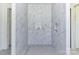 An unfinished primary bathroom features white marble-look tile walls and flooring at 6511 Rehobeth Rd, Waxhaw, NC 28173