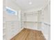 Walk-in closet with custom shelving and wooden floor at 6511 Rehobeth Rd, Waxhaw, NC 28173