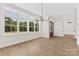 Bright dining room with large windows, chandelier, and light wood floors at 6511 Rehobeth Rd, Waxhaw, NC 28173