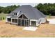 Rear exterior view of the home featuring a screened porch and a spacious patio area at 6511 Rehobeth Rd, Waxhaw, NC 28173