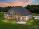 Beautiful home at twilight showcasing outdoor lighting and a screened-in porch for relaxation at 6511 Rehobeth Rd, Waxhaw, NC 28173