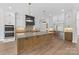Open kitchen featuring a large island, pendant lighting, and high-end stainless steel appliances at 6511 Rehobeth Rd, Waxhaw, NC 28173