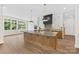 Stylish kitchen with a large island, pendant lighting, modern appliances, and ample natural light at 6511 Rehobeth Rd, Waxhaw, NC 28173