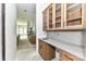 A kitchen area features wood cabinets, drawers, shelving, a sink, and gray marbled countertops at 6511 Rehobeth Rd, Waxhaw, NC 28173