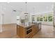Open kitchen with a large island, hardwood floors, modern appliances and easy access to patio at 6511 Rehobeth Rd, Waxhaw, NC 28173