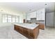 A kitchen area features unfinished floors, white cabinets, and a gray and white marbled kitchen island at 6511 Rehobeth Rd, Waxhaw, NC 28173