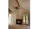 Bright living room with vaulted ceilings, stone fireplace, and doors leading to outdoor area at 6511 Rehobeth Rd, Waxhaw, NC 28173
