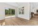 Well-lit room with hardwood floors and views of the backyard, seamlessly connected to other parts of the home at 6511 Rehobeth Rd, Waxhaw, NC 28173