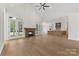 Open living room with a stone fireplace, hardwood floors, and seamless flow to the kitchen at 6511 Rehobeth Rd, Waxhaw, NC 28173
