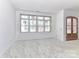 An unfinished living room features an unfinished floor, large windows, and a front entry door at 6511 Rehobeth Rd, Waxhaw, NC 28173