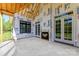 A covered patio area features an indoor/outdoor fireplace and several doors and windows at 6511 Rehobeth Rd, Waxhaw, NC 28173