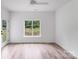 Bright bedroom with wood-look floors and a large window that fills the space with natural light at 6907 Lancaster Hwy, Waxhaw, NC 28173