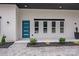 Modern home with a blue entry door and meticulously maintained landscaping at 6907 Lancaster Hwy, Waxhaw, NC 28173