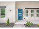 Contemporary home with a modern blue door and manicured landscape at 6907 Lancaster Hwy, Waxhaw, NC 28173