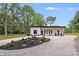 Modern home featuring a gravel driveway and minimalist landscaping at 6907 Lancaster Hwy, Waxhaw, NC 28173