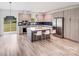 Bright kitchen features an island with seating, stainless steel appliances, modern cabinets, and backyard views at 6907 Lancaster Hwy, Waxhaw, NC 28173