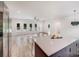 Open-concept living room with light wood floors, white walls, a ceiling fan, and abundant natural light at 6907 Lancaster Hwy, Waxhaw, NC 28173