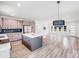 Open-concept living room and kitchen space with light wood floors and modern finishes at 6907 Lancaster Hwy, Waxhaw, NC 28173