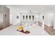 Open-concept living room with light wood floors, white walls, a ceiling fan, and abundant natural light at 6907 Lancaster Hwy, Waxhaw, NC 28173