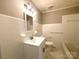 Well-lit bathroom featuring a single sink vanity with marble floor tiles at 717 Wilshire Sw Ave, Concord, NC 28025