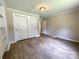 Comfortable bedroom featuring neutral walls, closet, and attractive wood-look flooring at 717 Wilshire Sw Ave, Concord, NC 28025