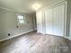 Sunlit bedroom showcasing laminate floors and closet space at 717 Wilshire Sw Ave, Concord, NC 28025