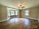 Bright bedroom with neutral walls, many windows, and attractive wood-look flooring at 717 Wilshire Sw Ave, Concord, NC 28025