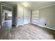 An airy bedroom with wood-look floors, closet space, and fresh neutral paint at 717 Wilshire Sw Ave, Concord, NC 28025