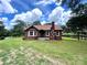 Charming brick home featuring a well-maintained lawn, brick chimney, and inviting front porch at 717 Wilshire Sw Ave, Concord, NC 28025