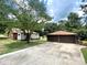 A two-car garage near a charming single-story home on a tree-filled lot at 717 Wilshire Sw Ave, Concord, NC 28025