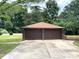 A two car garage with a concrete drive on a well maintained lawn at 717 Wilshire Sw Ave, Concord, NC 28025