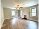 Bright living room with a decorative fireplace, neutral walls, bright windows, and stylish flooring at 717 Wilshire Sw Ave, Concord, NC 28025