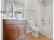 Well-lit bathroom featuring a single sink vanity, a toilet and a shower/tub combination at 7753 Jackson Pond Dr, Charlotte, NC 28273