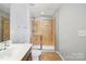 Bathroom with shower featuring glass doors, toilet, and vanity at 7753 Jackson Pond Dr, Charlotte, NC 28273
