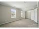 Bedroom featuring carpet, bright window and walk-in closet at 7753 Jackson Pond Dr, Charlotte, NC 28273