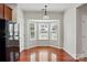 Inviting breakfast nook with a bay window, hardwood floors, and a view of the outdoors at 7753 Jackson Pond Dr, Charlotte, NC 28273