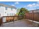 Exterior shot of a wooden deck, with a wooden fence, with a view of the back of the house at 7753 Jackson Pond Dr, Charlotte, NC 28273